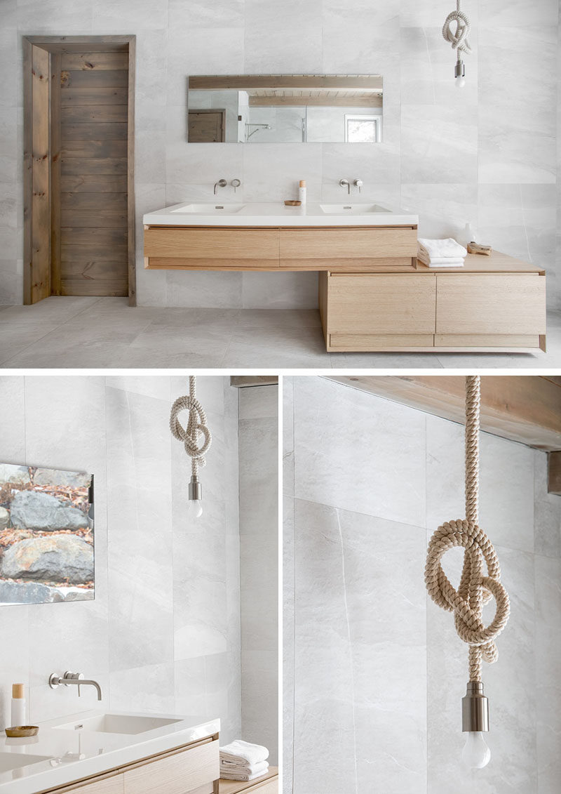 This ensuite bathroom vanity, made from light wood, includes dual sinks, ample storage, and a knotted pendant light to tie together the rustic feel of the space.