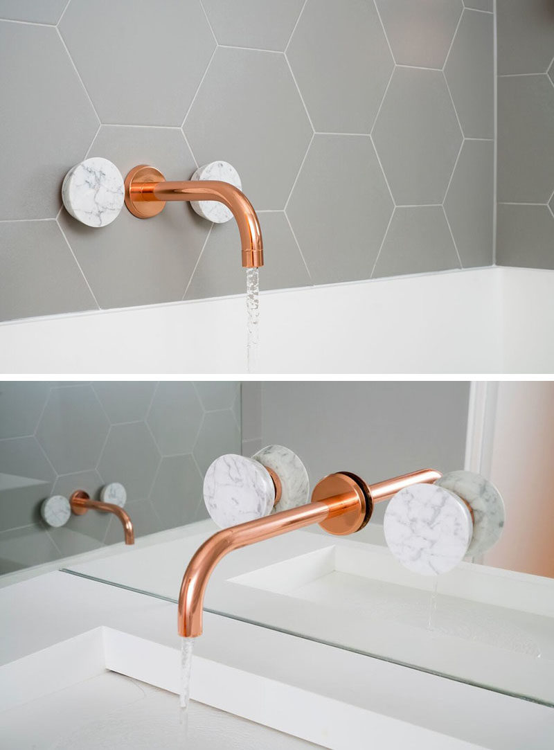 This Bathroom Features Copper And Marble Fixtures Next To Light Gray Hexagon Tiles