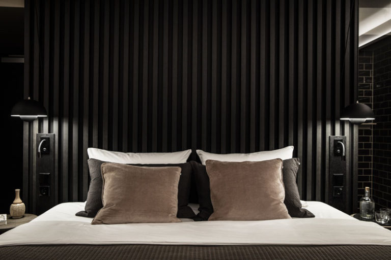 Create A Dramatic And Dark Bedroom With A Black Headboard