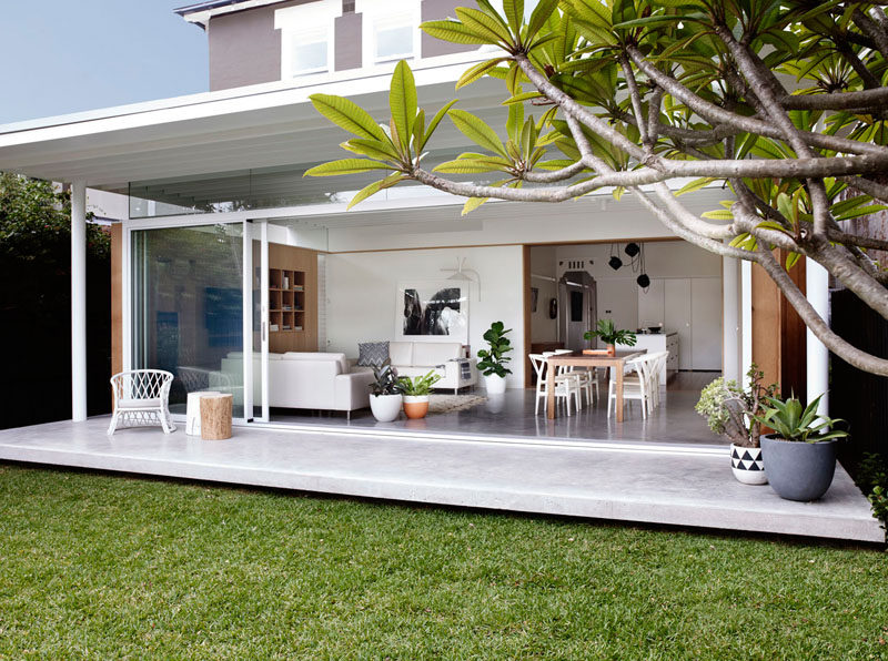 What was once a duplex has now been transformed into a single family home by Madeleine Blanchfield Architects, with a extension that opens up the living and dining room to the backyard.