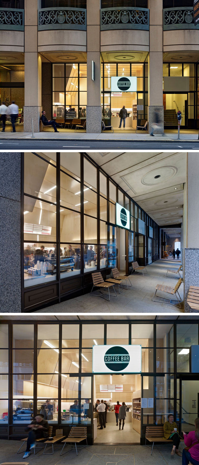 The interior of this coffee shop has the walls and ceiling covered in plywood. Embedded within the plywood walls are strips of lighting creating a unique and artistic design.