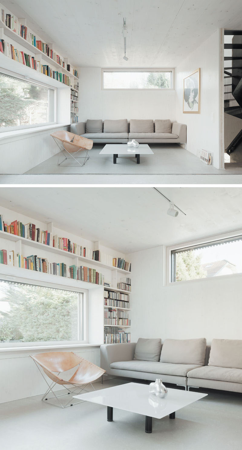 Bookshelves wrap around the window in this small and modern living room.