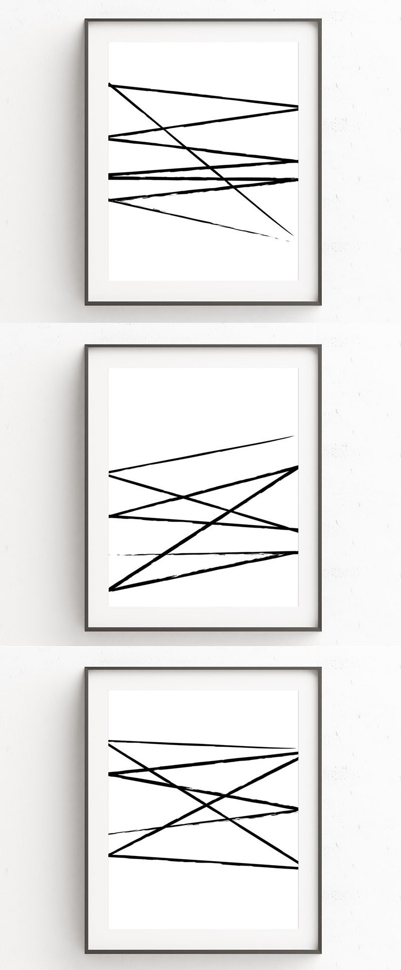 Oju Design has created a series of modern black and white wall art prints that have fierce and imperfect brush strokes slashed across a white background.