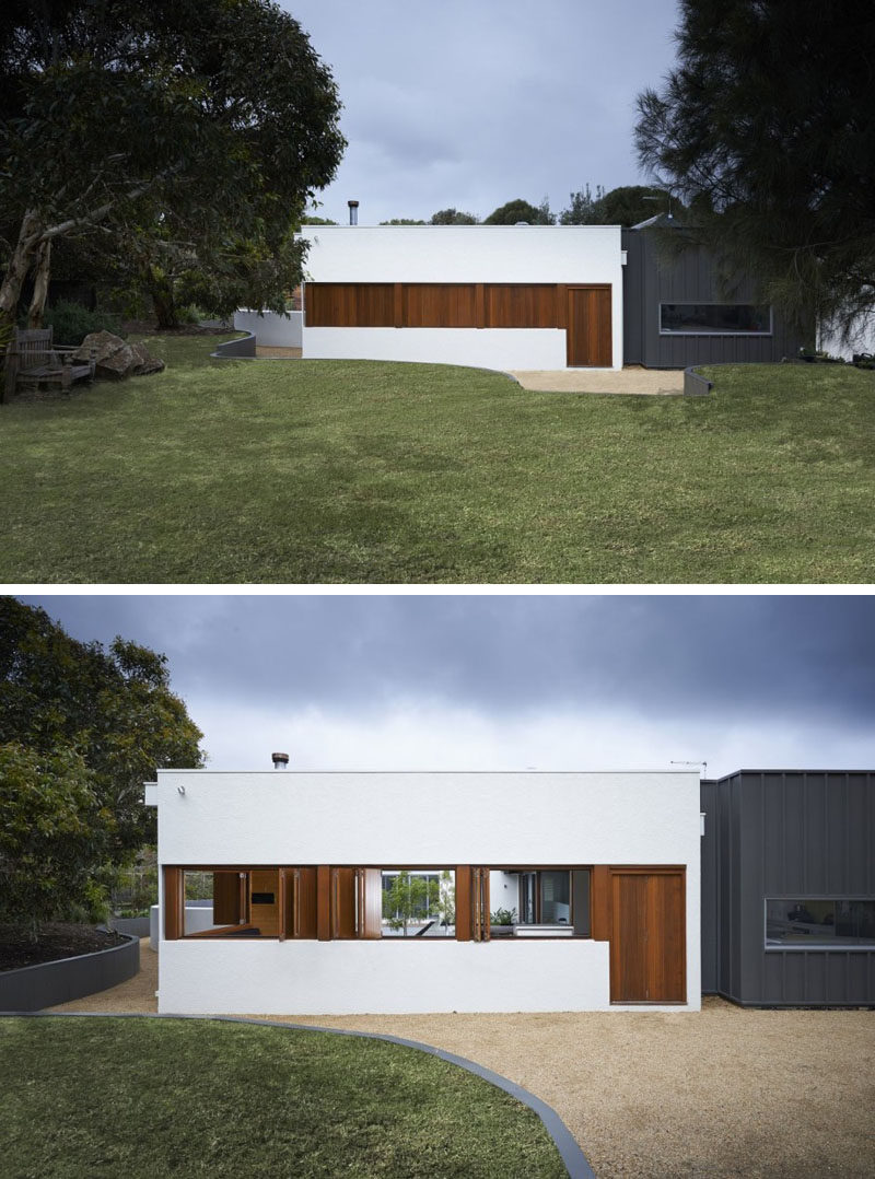 12 Minimalist Modern House Exteriors // The combination of white, wood, and black on the exterior of this minimalist home make it look warm and inviting despite its simple design.