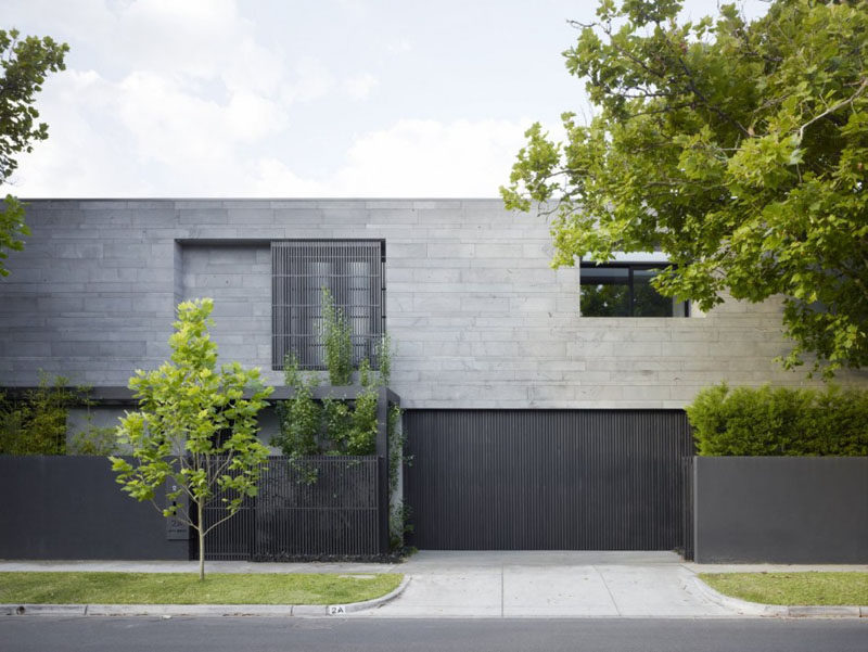 12 Minimalist Modern House Exteriors // Dark materials on the exterior of the house give it a minimalist look and contrast the greenery surrounding it.