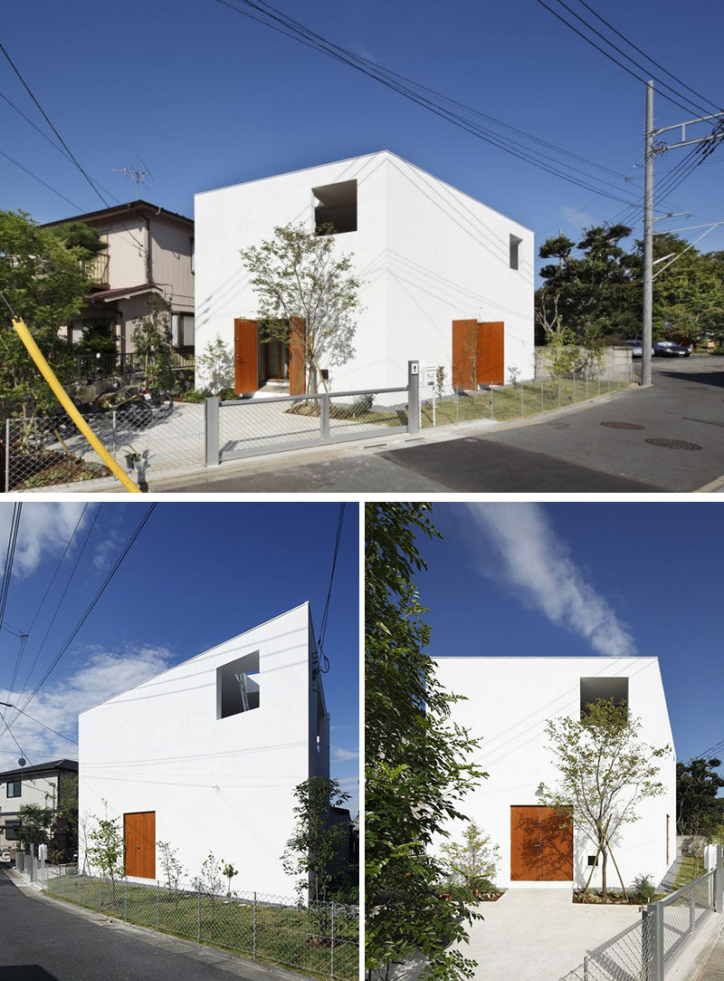 12 Minimalist Modern House Exteriors // The all white angular exterior of this house is warmed up with the wood doors but maintains a simple, minimalist look.