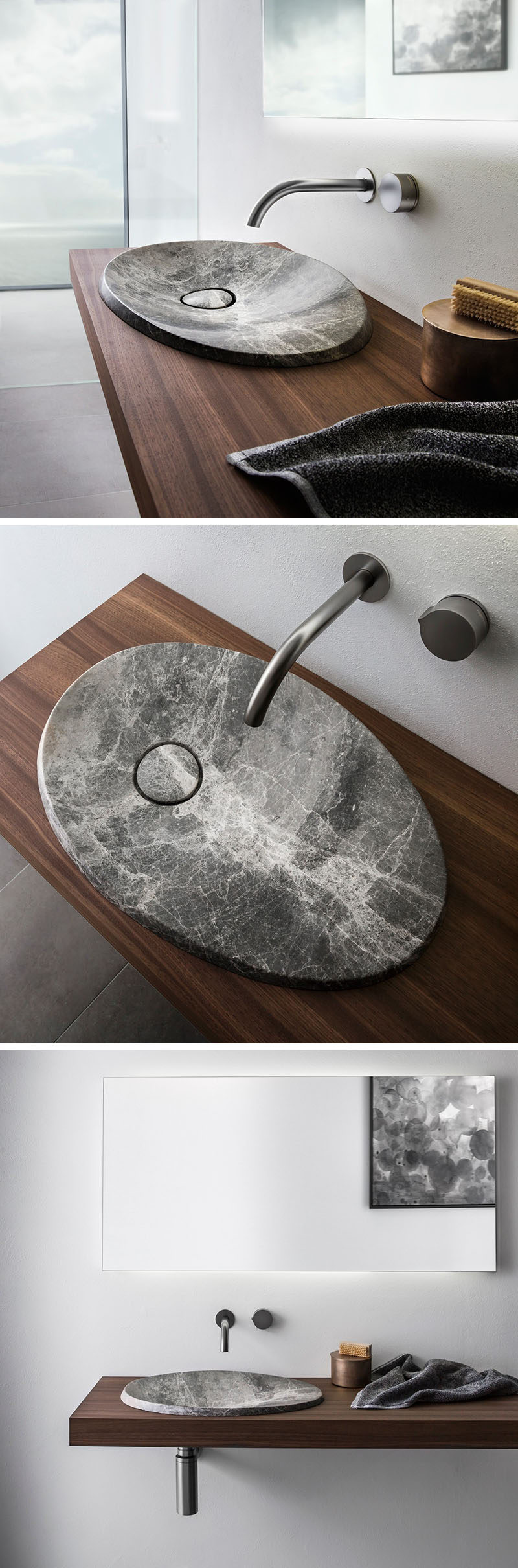 This modern bathroom sink made from natural stone sits on a floating wood vanity and has a simple stainless steel faucet.