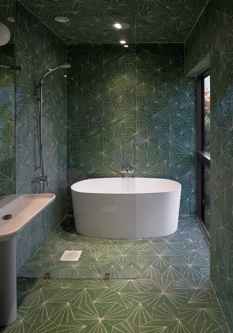 Bathroom Tile Idea - Use The Same Tile On The Floors And The Walls | Not only have the same patterned green tiles been used on the walls and floors of this bathroom, they've also been used on the ceiling!