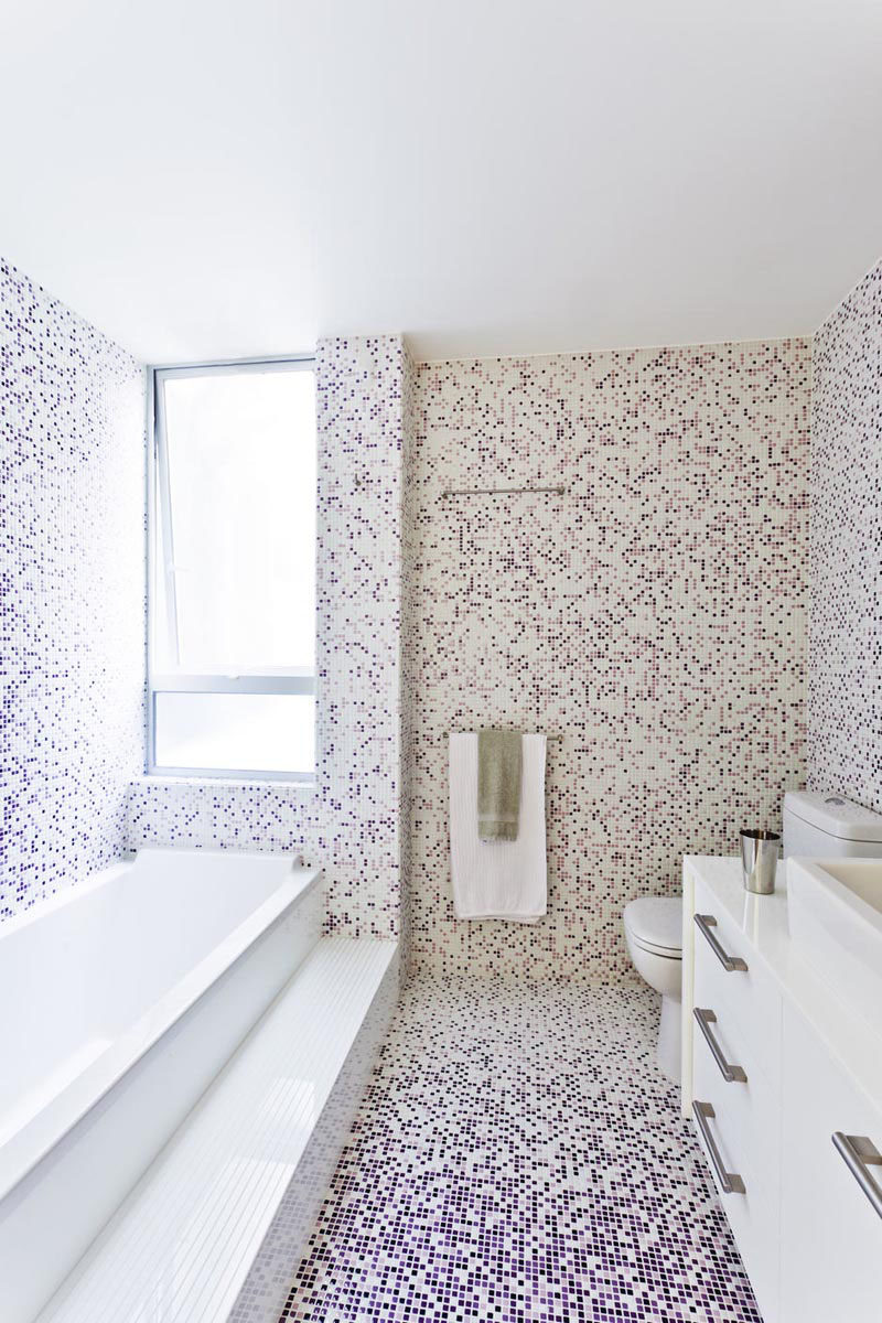 Bathroom Tile Idea - Use The Same Tile On The Floors And The Walls | Tiny purple and white tiles have been placed over the floors and walls of this bright bathroom to create a pixel effect.