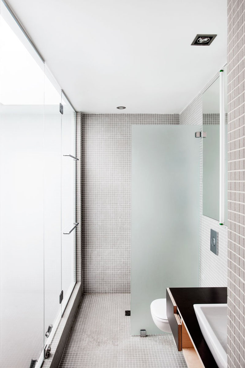 Bathroom Tile Idea - Use The Same Tile On The Floors And The Walls | Grey tiles used on the floors and walls of this bathroom create a neutral and relaxing space.