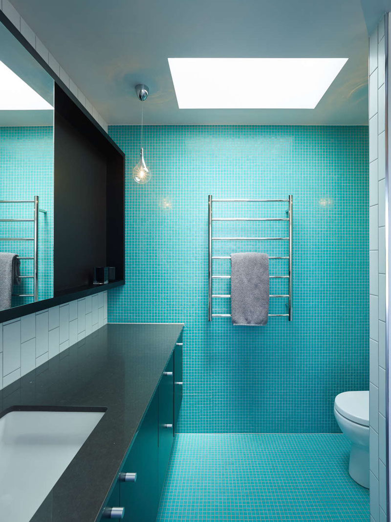 Bathroom Tile Idea - Use The Same Tile On The Floors And The Walls | Tiny bright blue tiles cover the floor and one of the walls in this bathroom to add a bold punch of color.