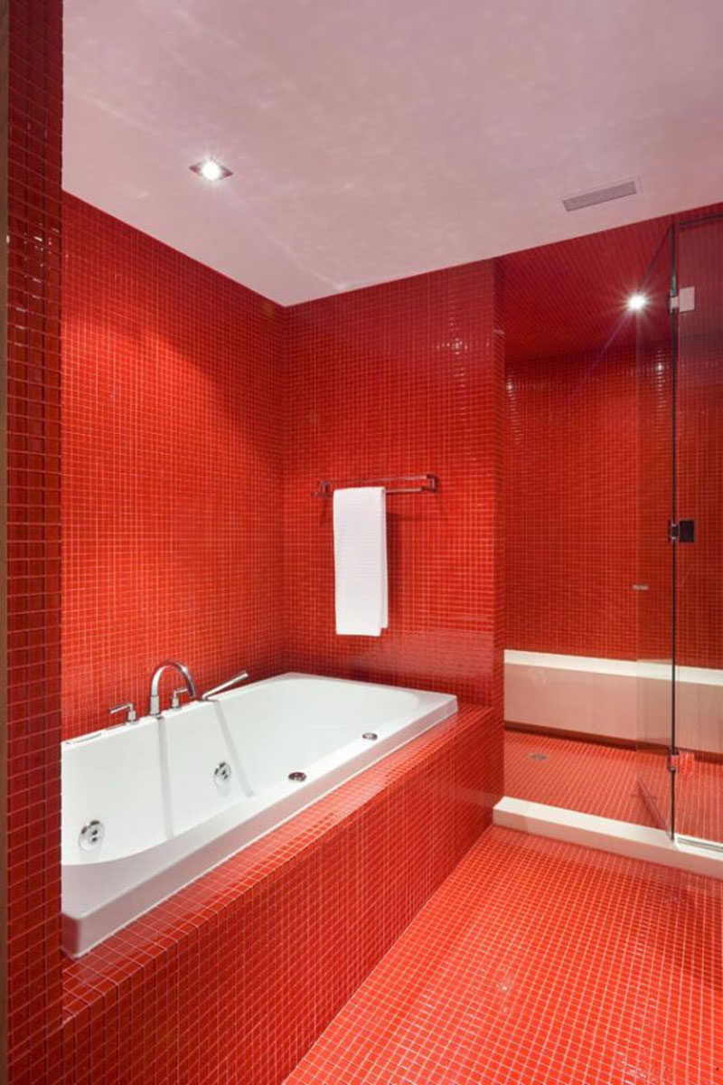 Bathroom Tile Idea - Use The Same Tile On The Floors And The Walls | Bright red square tiles cover the floors and walls of this bathroom making a strong statement when you walk in.