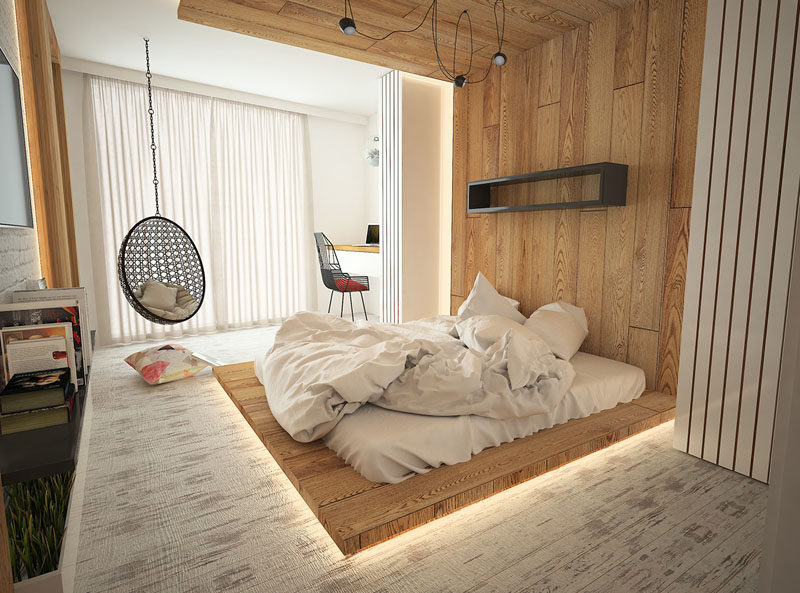 Installing hidden lighting in your modern bedroom is a great idea if you want to create a warm soft glow throughout your room. In this bedroom, hidden LED lighting was used underneath and behind the floor-to-ceiling wooden headboard.