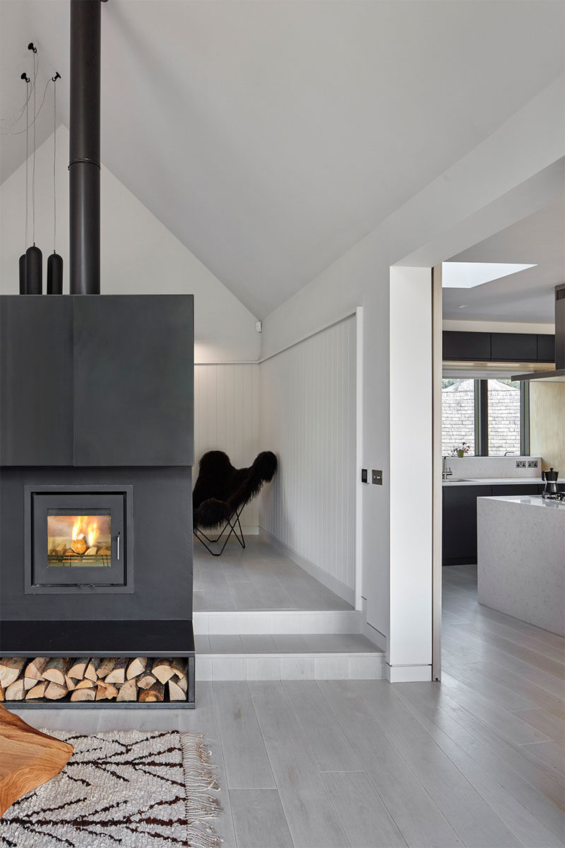 Tucked away behind this steel-clad fireplace with firewood storage is a small library.