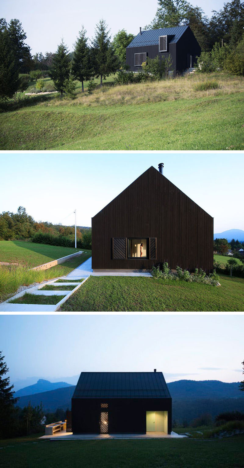 This small modern black house sits on a slope in the countryside of Croatia.