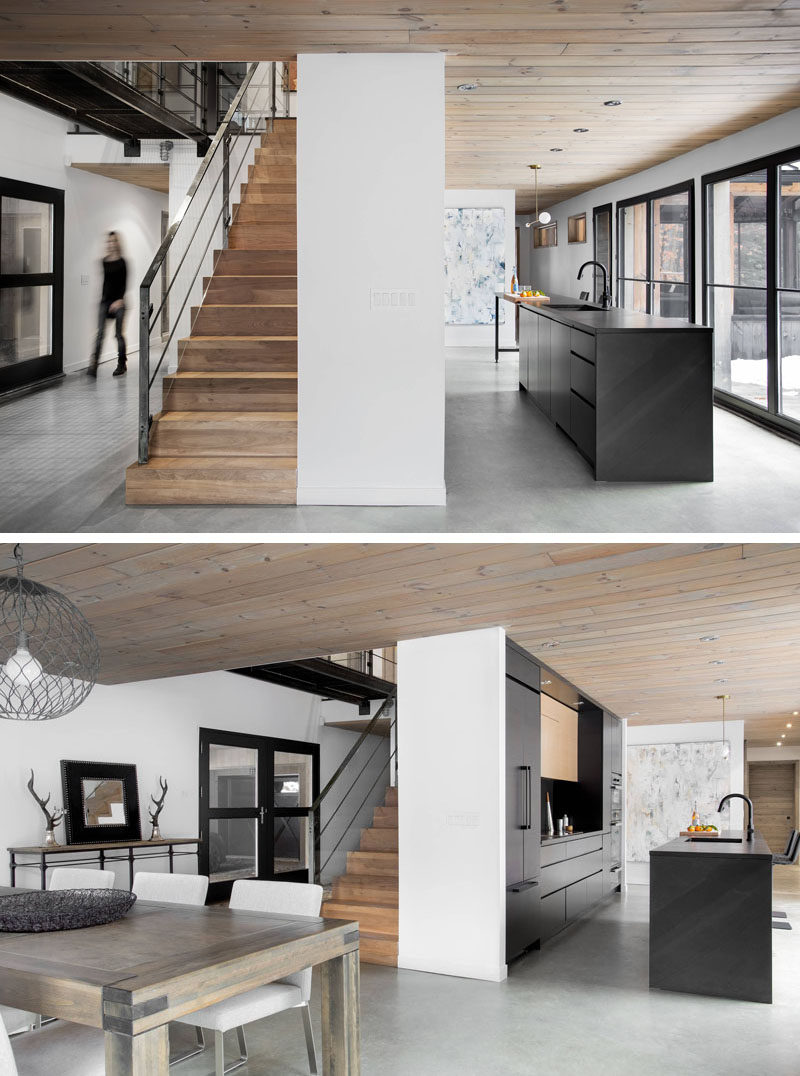 This modern black kitchen stands out against the light floors and white walls, and fits right in with all of the other black elements found in the home.