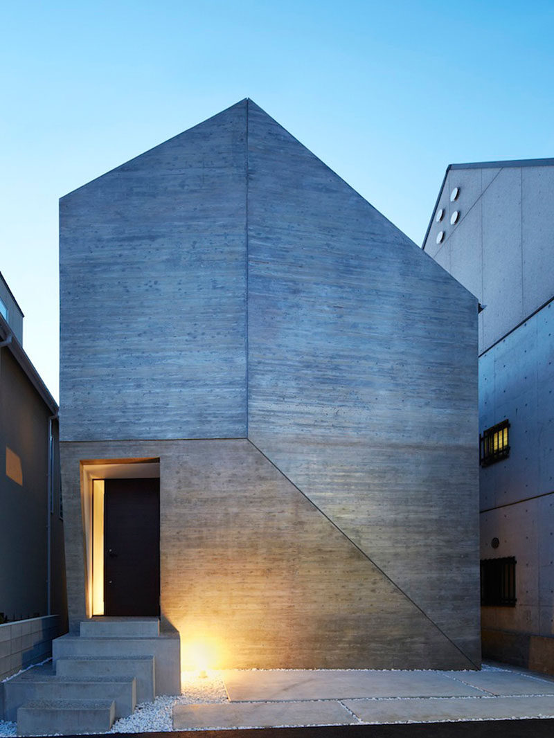 13 Modern House Exteriors Made From Concrete | The way the concrete has been joined on the front of this house gives it a geometric look that's only interrupted by the cutout for the door.