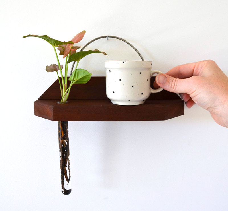 These modern hanging wall shelves made from reclaimed wood have a ledge to display a little trinket and a bud vase for a flower.