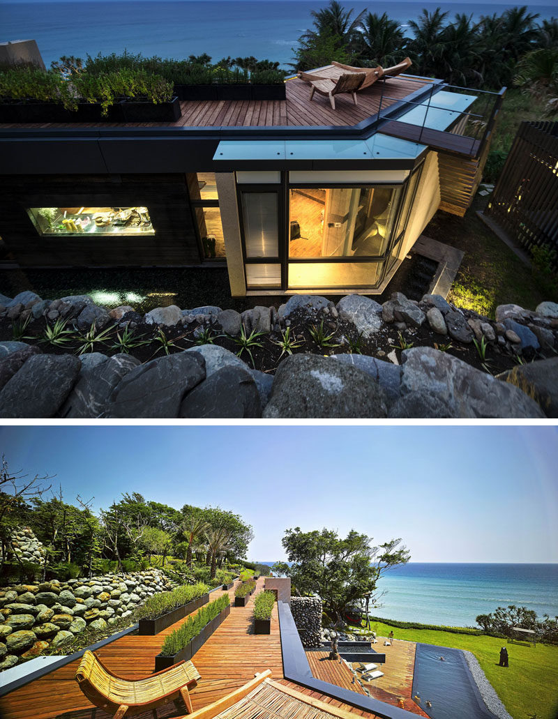 On the roof of this modern house is a rooftop deck, with ocean views as far as the eye can see. The plants in the black planters on the roof are a variety of herbs that are used in the kitchen.