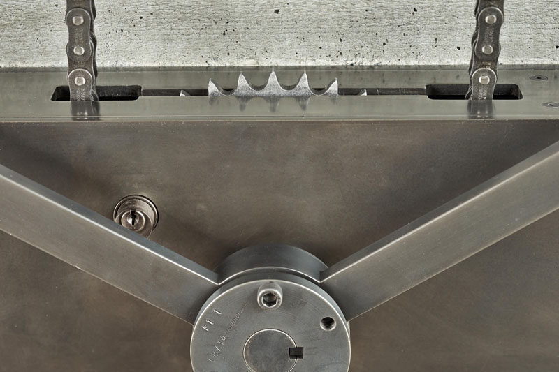 Industrial elements like this hand-crank wheel are used in the design of this house to open a large pivoting glass wall.