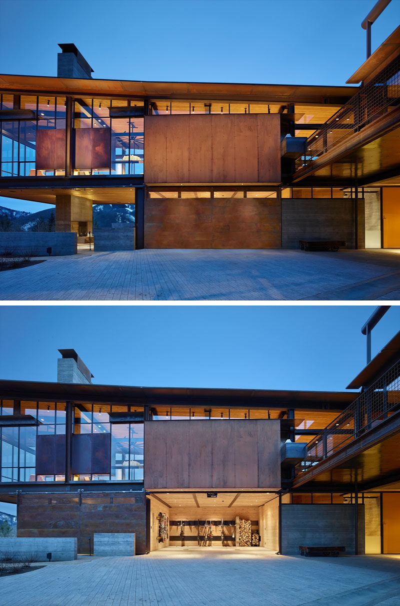 The roof of this modern industrial home is made of corrugated weathered steel that slopes slightly and matches the garage door.