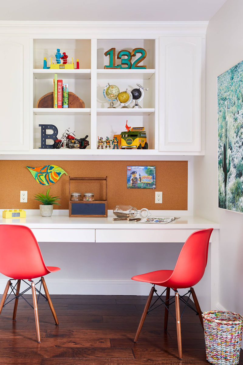 This kids bedroom design features a homework station along one wall, and a custom bulletin board provides the perfect place to pin inspiration, photos, or notes.