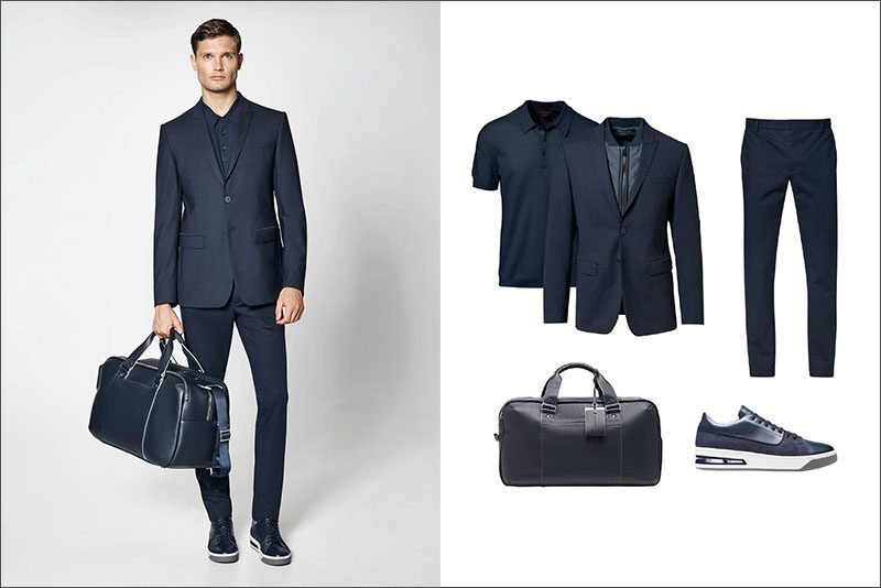 Men's Fashion Ideas - 17 Men's Outfits From Porsche Design's 2017 Spring/Summer Collection | This monochrome men's outfit pairs a slim fitting navy blazer with a navy knit polo shirt, crisp navy cotton pants, casual navy sneakers, and navy leather weekend bag.