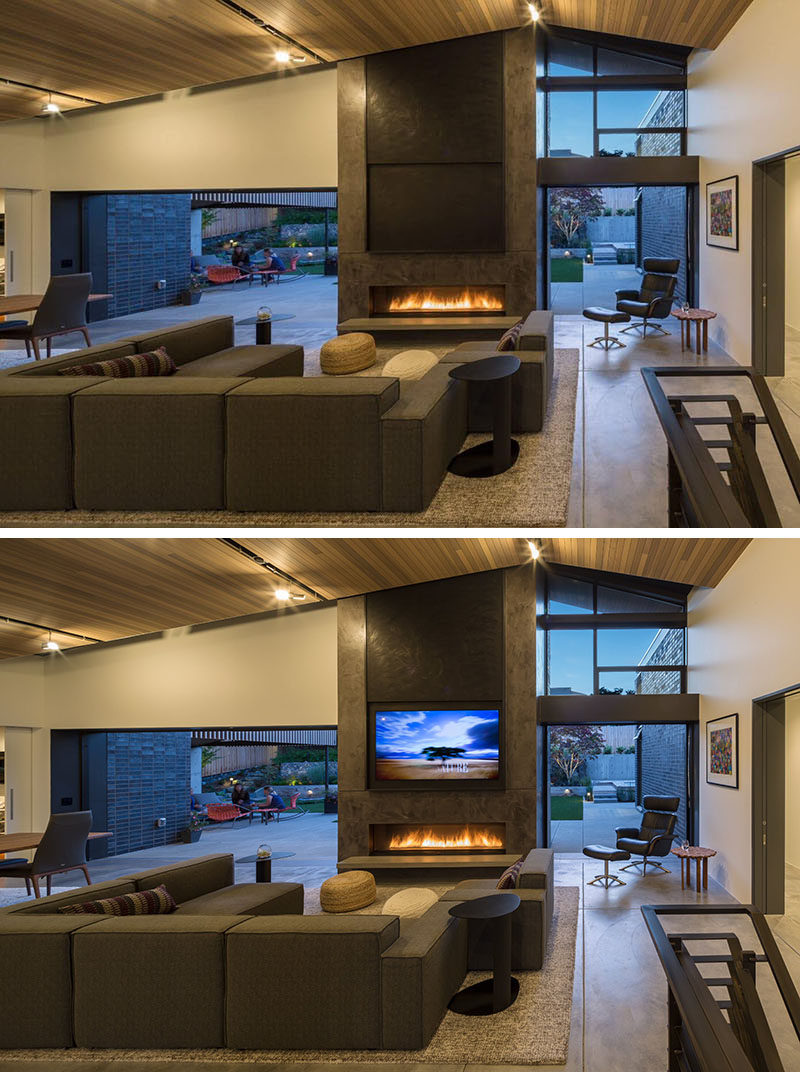 Inside this modern home, there are sliding glass pocket doors that disappear into wall to create an indoor/outdoor living experience. The living room has a vaulted tongue and groove cedar ceiling. Sitting above the gas fireplace is a motorized panel that can be raised to reveal the television.