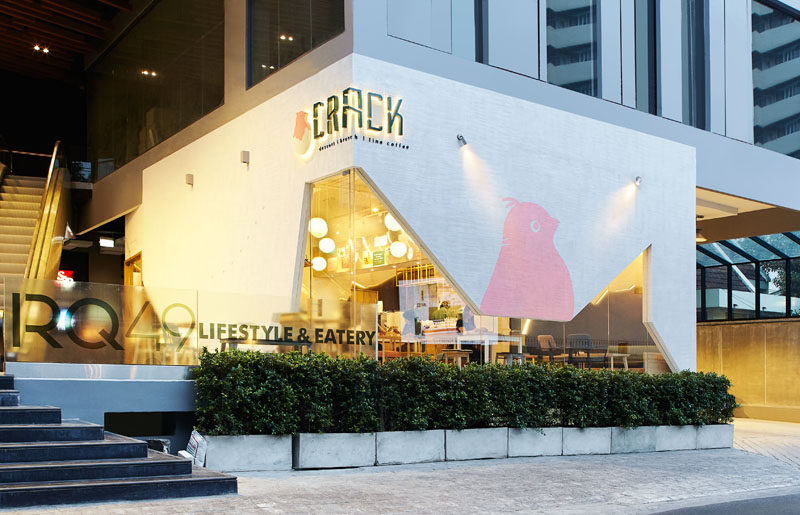 This modern dessert restaurant in Bangkok, Thailand, has an angular facade, much like a cracked egg shell.