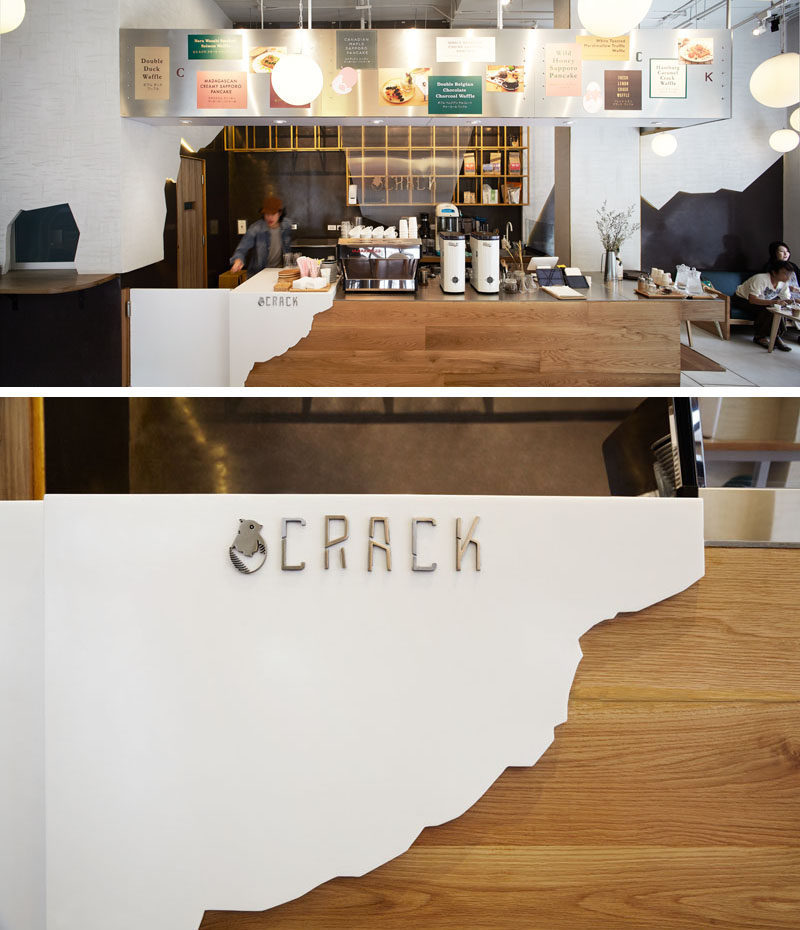 This wooden service counter is partially covered with a 'white egg shell' and the logo, that fits in with the cracked shell theme found throughout the design of the restaurant.