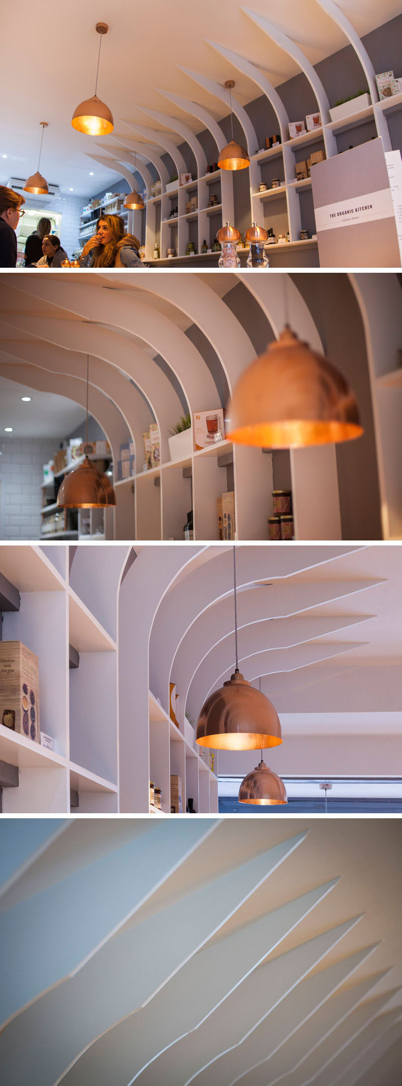 This modern restaurant interior features a copper pendant lights throughout, and a sculptural shelving unit displays the various products that they sell.