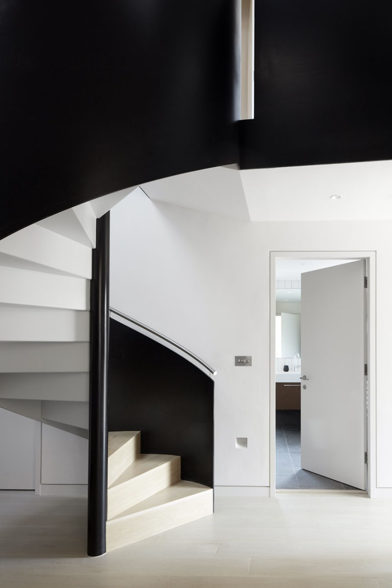 These spiral stairs have a color palette of black, white and wood.