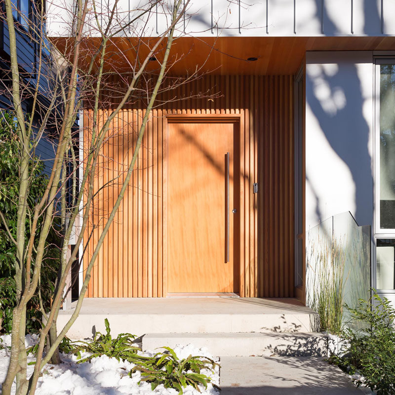 Wood surrounds the entryway and front door of this modern home. The wood used is Douglas Fir.