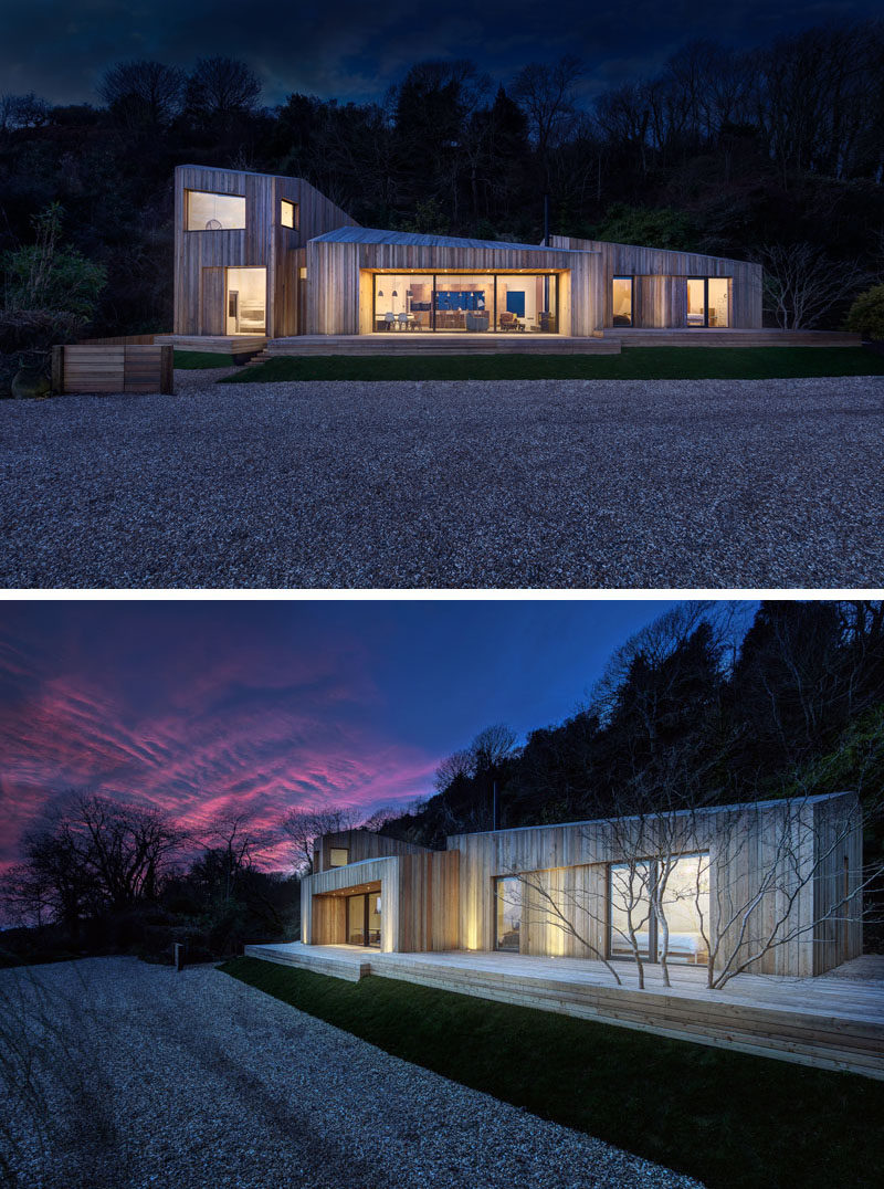 At night, this modern holiday home has uplighting on the facade creating a soft glow on the house.