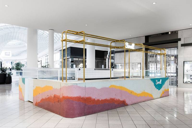 Layers of colorful concrete were poured onsite into a formwork mold to create a bar for Scroll Ice Cream's flagship store in Australia.