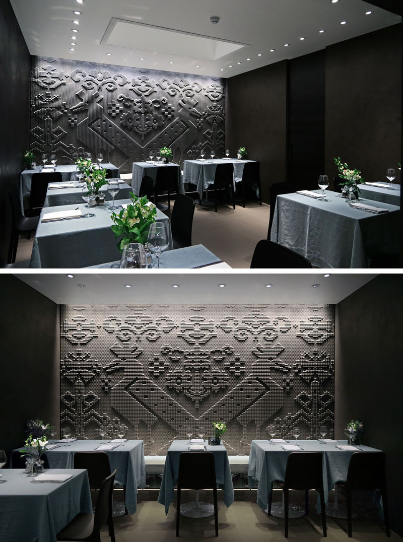 Wall Decor Ideas - In the dining area of this modern restaurant is a stone tapestry that covers the entire wall with pattern inspired by the lapwing bird.