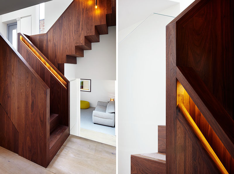 This American black walnut stairs has hidden lighting in the built-in handrails to light up the staircase and make the handrail easier to find.