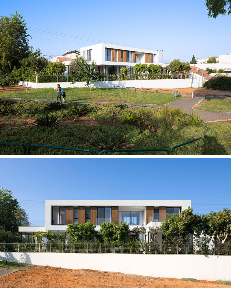 Shachar- Rozenfeld architects have designed this 'L' shaped modern home in Rishon LeZion, Israel, that sits on a narrow trapezoid lot and borders a small public park.