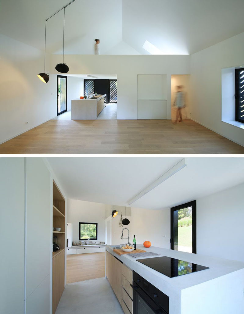 The interior of this small modern house is bright, lofty and open. Upon entering the interior, you walk into the kitchen that has an island housing the cooktop and sink. Behind the kitchen is the bathroom and above it is a mezzanine with a sleeping loft.