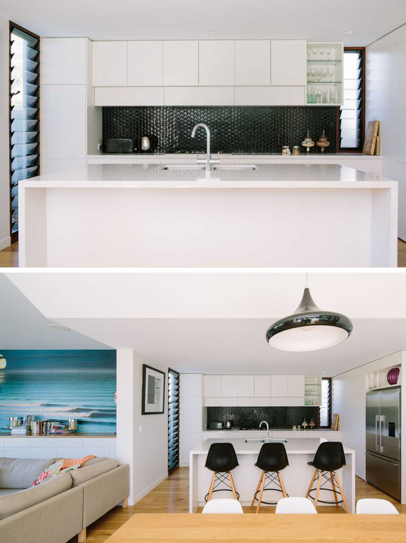 Kitchen Design Ideas - 9 Backsplash Ideas For A White Kitchen // Create a bit of contrast in your white kitchen with a super dark backsplash. Black tile is an easy way to do this but the look can also be achieved with a dark brushed metal or even a black glass.