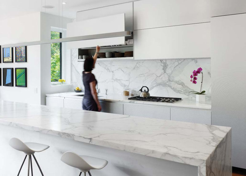 Kitchen Design Ideas - 9 Backsplash Ideas For A White Kitchen // Add a stone backsplash to an all white kitchen to compliment a stone island, continue the countertop or just stand on it's own as an accent.