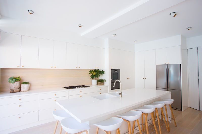 Kitchen Design Ideas - 9 Backsplash Ideas For A White Kitchen // While a wood backsplash isn't the best backsplash material, you can still achieve the wood look using tiles or glass. This is a great way to get the warm benefit of the wood look without having to deal with the maintenance and work that comes along with a real wood backsplash. 