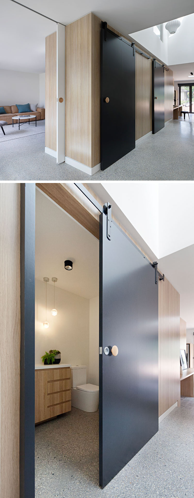 In the main floor of this modern renovated house, a central timber-clad pod has matte black sliding barn doors that conceals various rooms, like a small bathroom and cloak room.