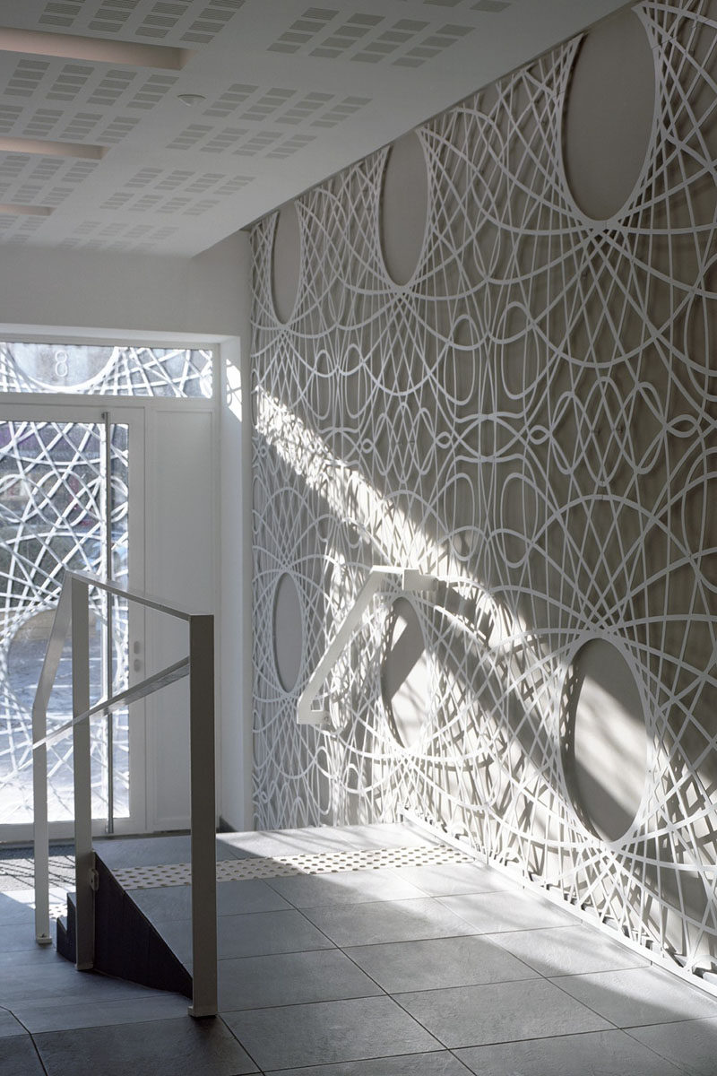 The lobby in this building features decorative concrete panels inspired by a pattern found on bank notes. The artistic panels also cover the facade of the building.