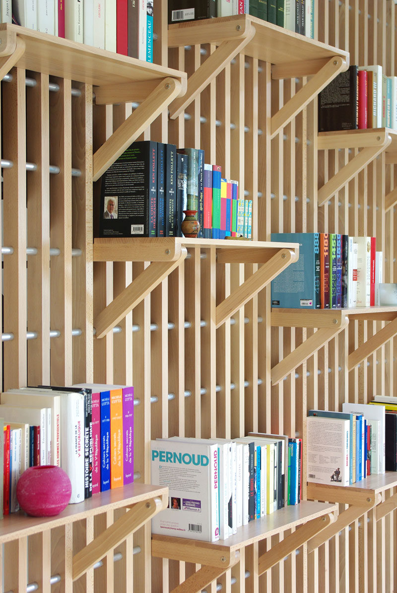 French designer Alexandre Pain created Rossignol, a custom designed wood shelf and railing system that can be used to store books and act as a guard rail for the staircase.