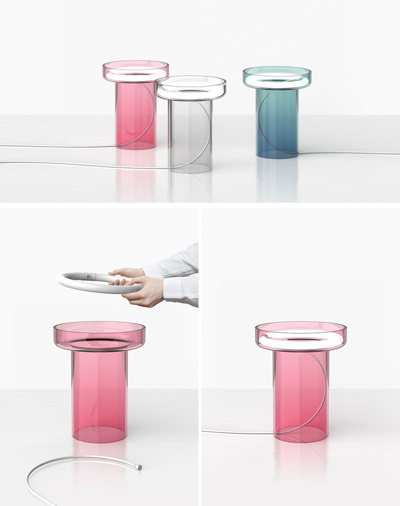 This clear, colored modern glass table lamp named HALO, has a handblown glass body with a circular light tucked inside it. HALO is available in grey, pink and blue and it is a limited edition piece.