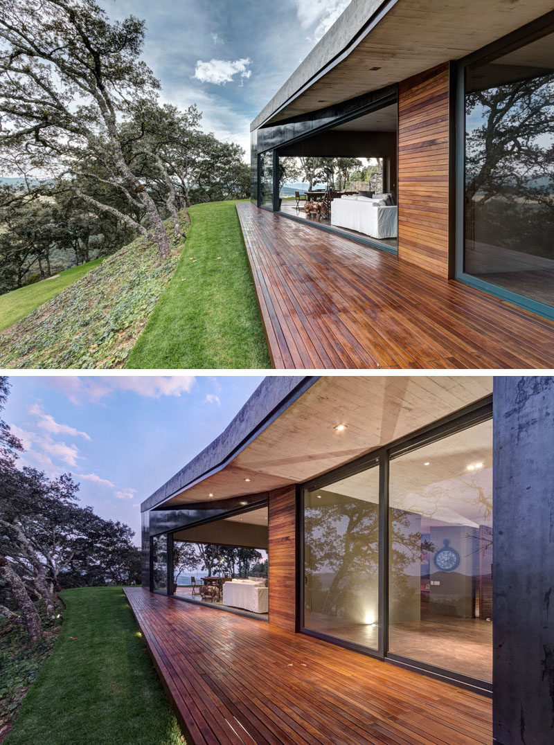 This modern house has a small wood deck that can be accessed through large sliding glass doors in the living room.