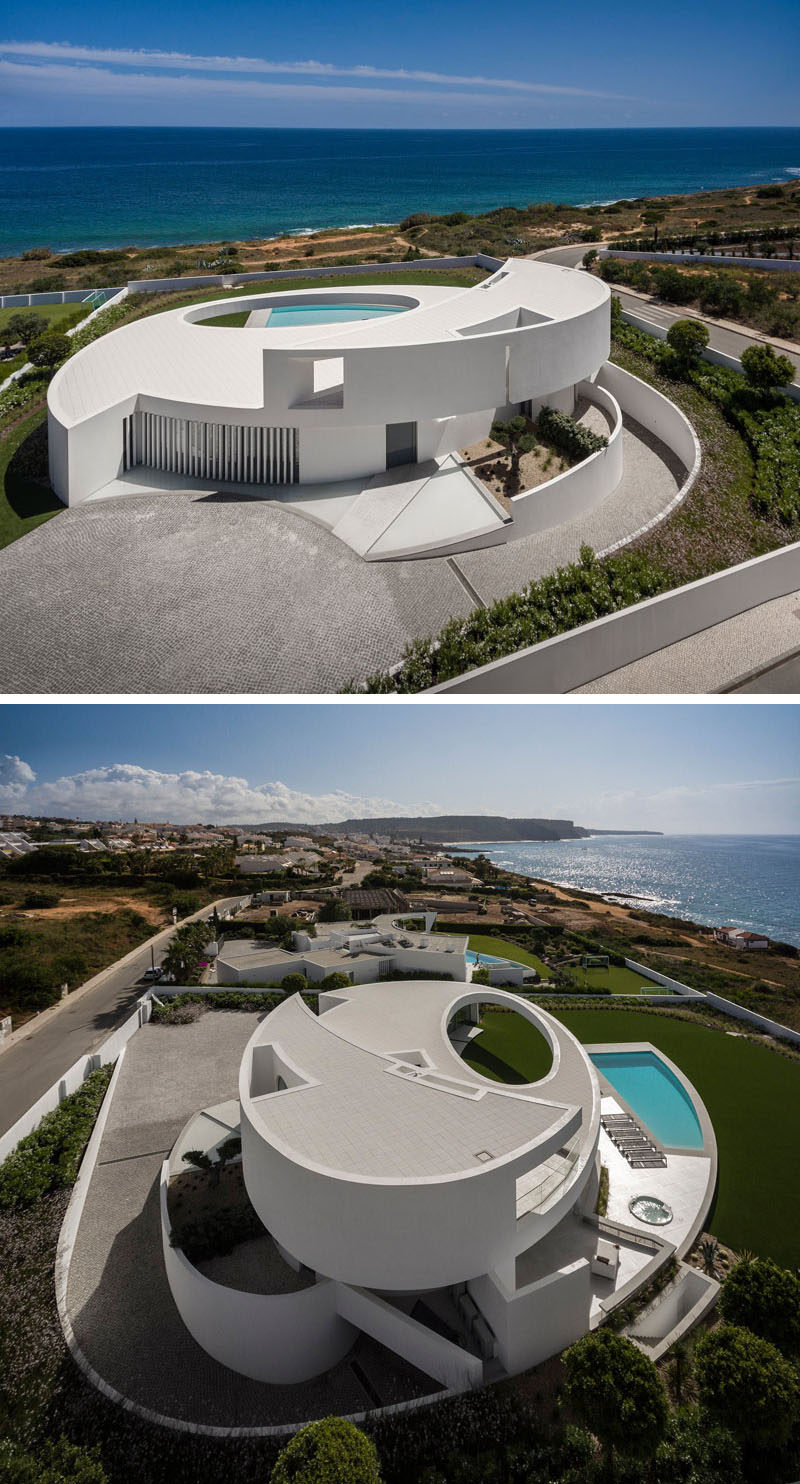 Mario Martins Atelier have designed this modern and sculptural house in Luz, Portugal, that's based on the geometric shape of an ellipse.