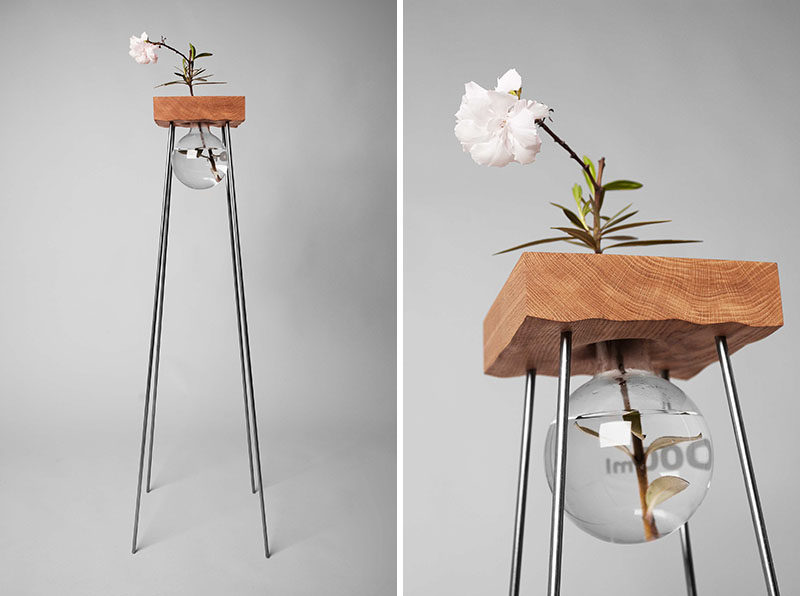 This tall wood and steel table with a simple glass vase has been designed to show off your flower arrangement.