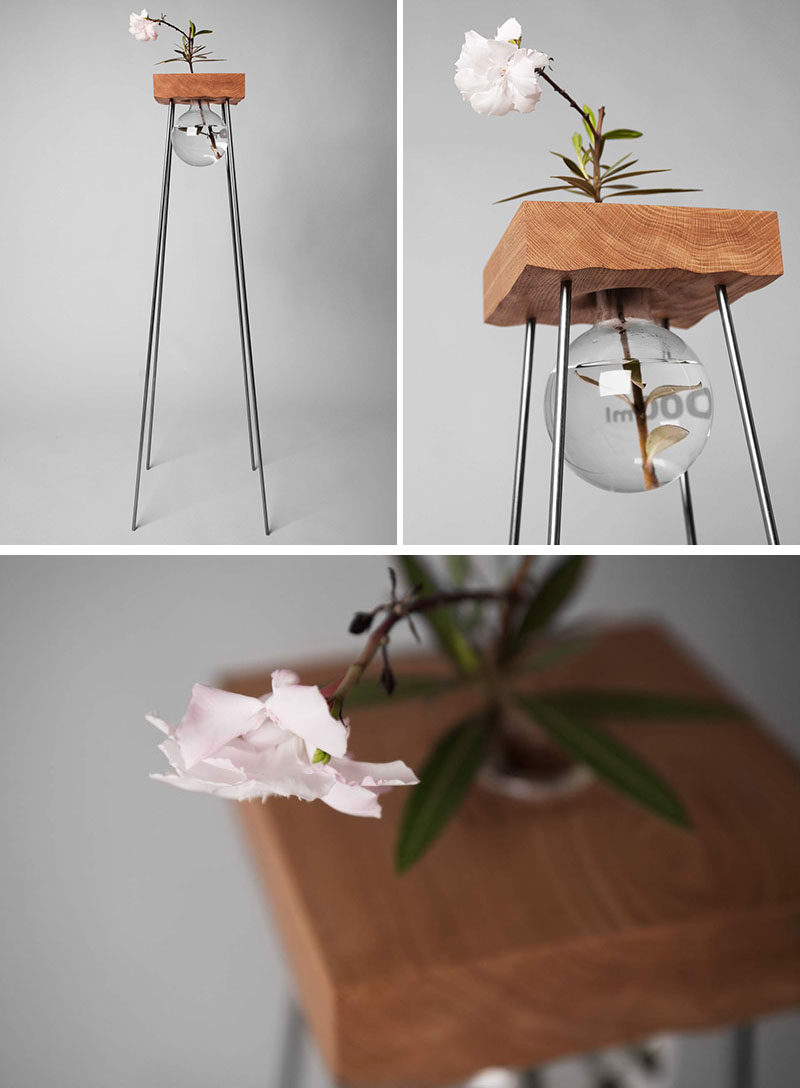 This tall wood and steel table with a simple glass vase has been designed to show off your flower arrangement.